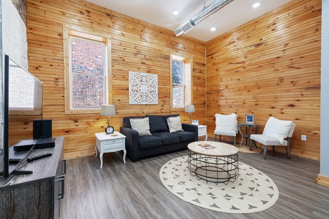Unit 202 — open kitchen and living area with warm wood interior